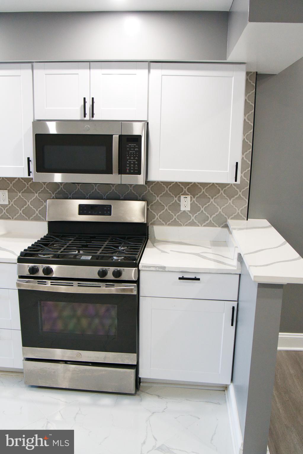 1604 Cliftview Avenue Baltimore, MD 21213 - Photo 8 of 34 a kitchen with a stove and a microwave