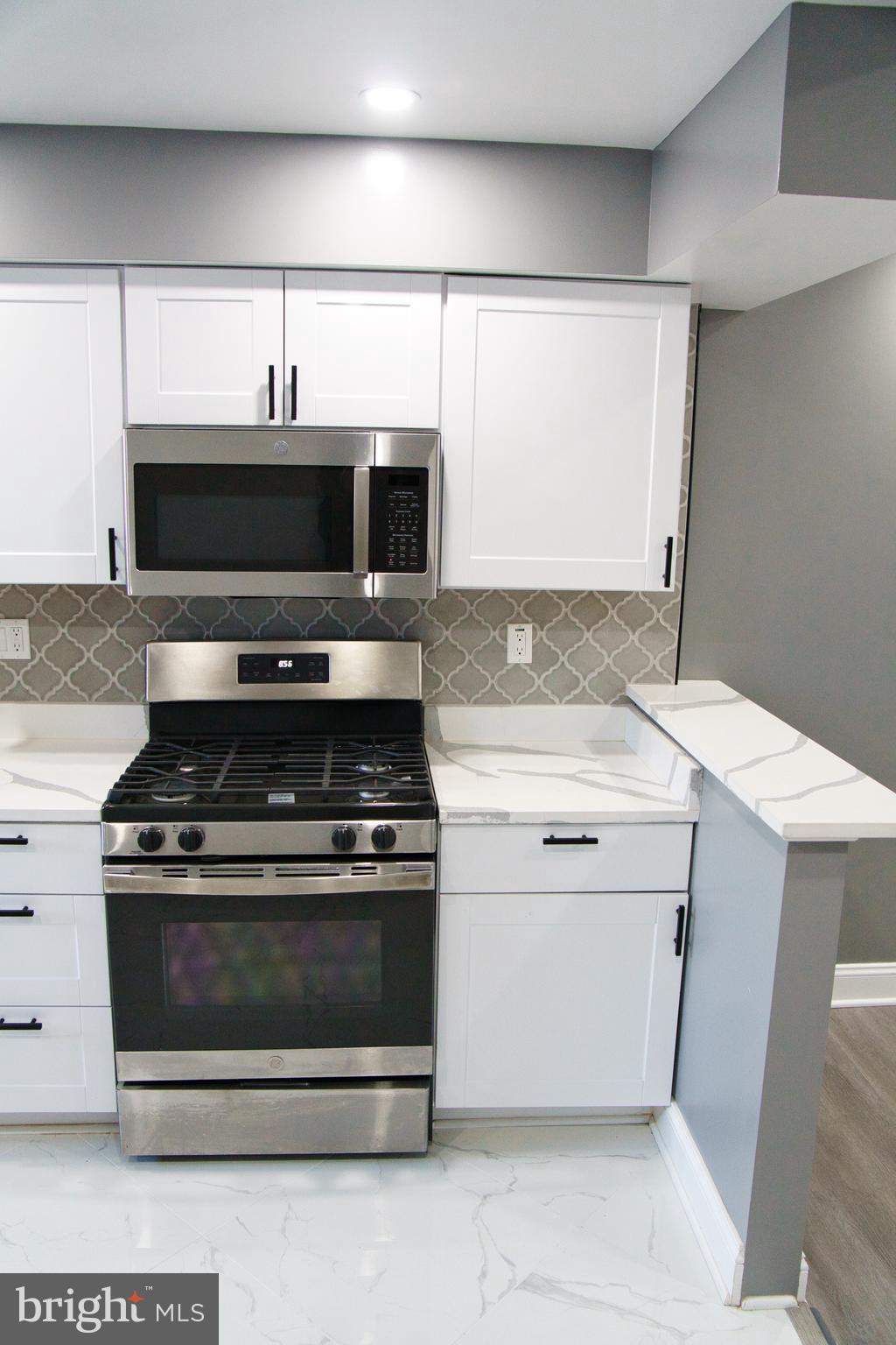 1604 Cliftview Avenue Baltimore, MD 21213 - Photo 9 of 34 a kitchen with a stove and a microwave