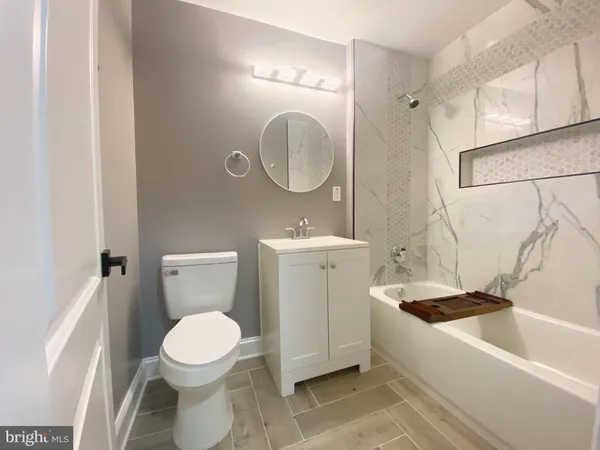 a bathroom with a sink toilet and a mirror
