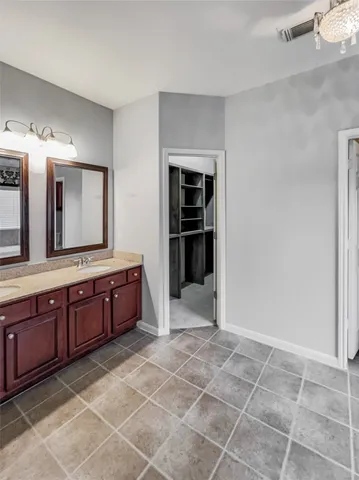 a spacious bathroom with a granite countertop sink mirror and a bathtub