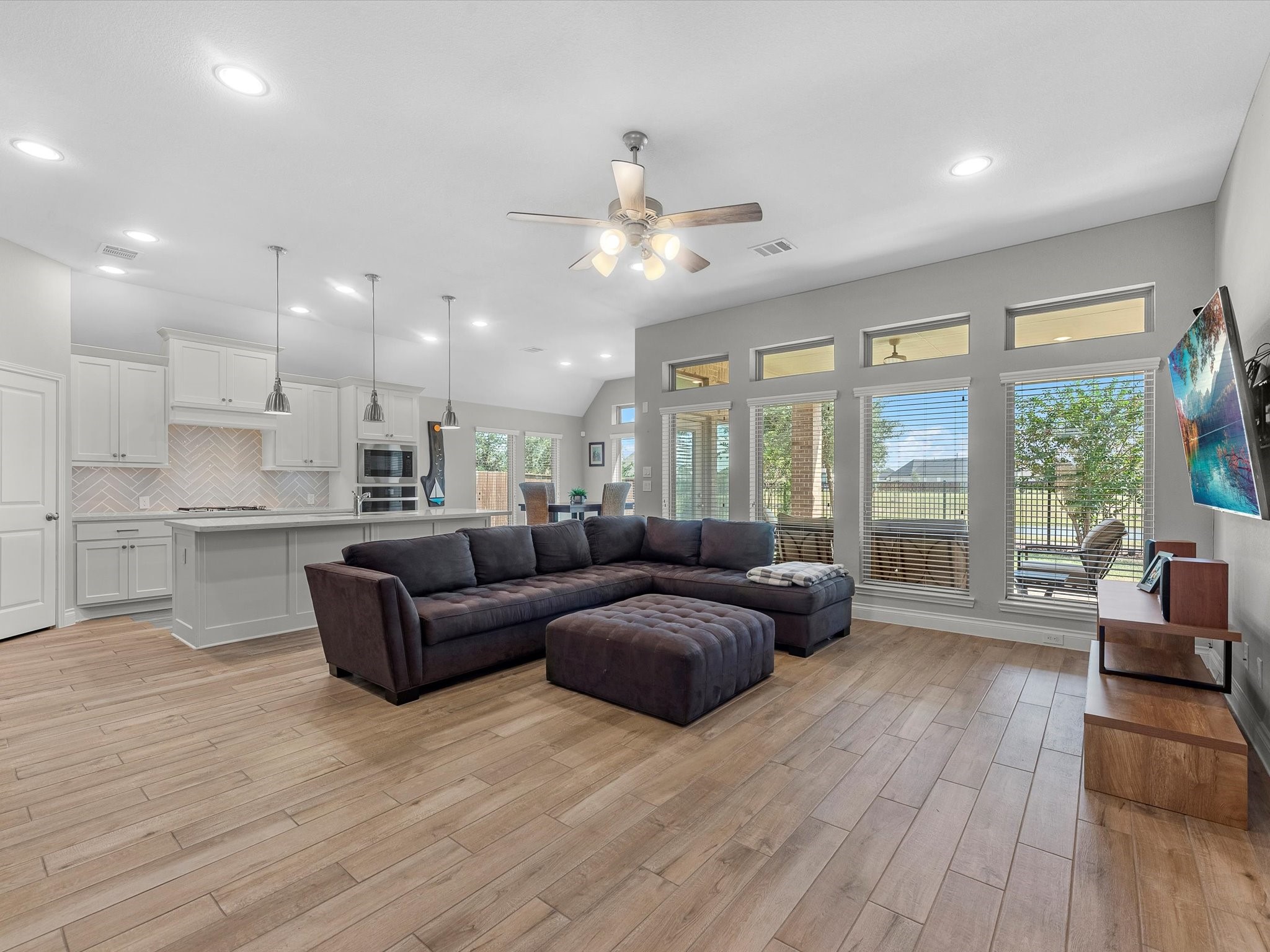 10135 Napier Drive Rosharon, TX 77583 - Photo 5 of 36 The open-concept living room is perfect for entertaining, offering a seamless flow and beautiful views of the backyard and water beyond.