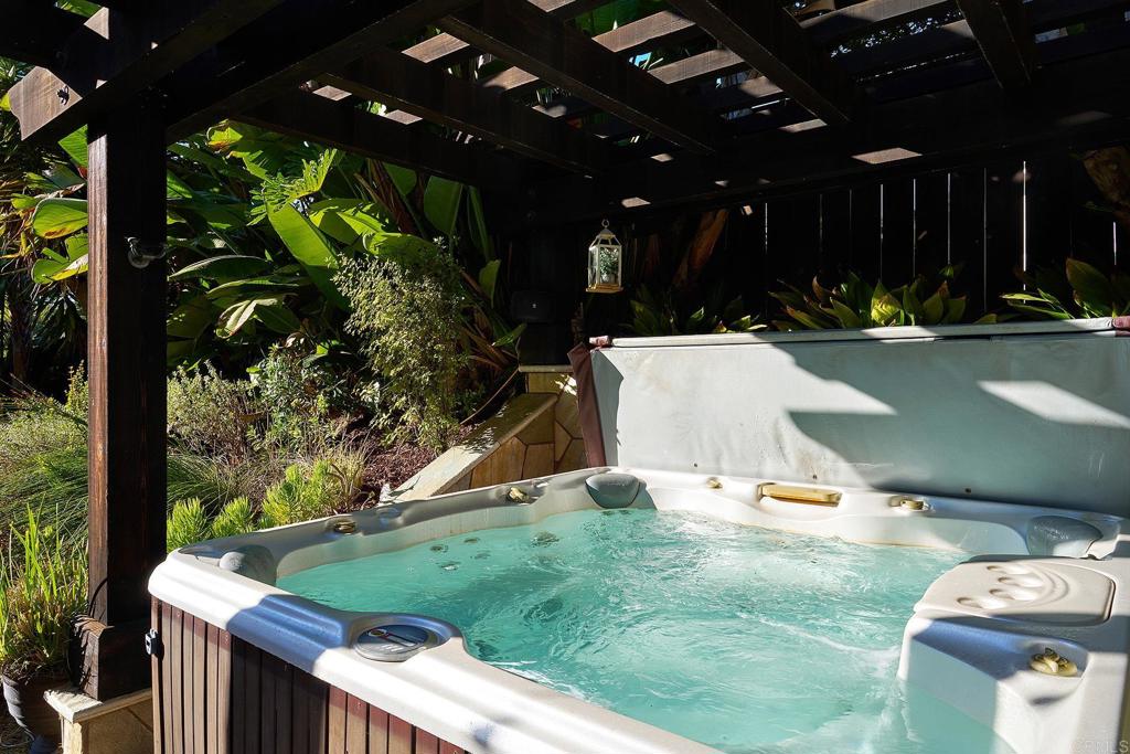 1323 Calle Scott Encinitas, CA 92024 - Photo 28 of 28 a view of a patio with table and chairs a barbeque with plants and palm trees