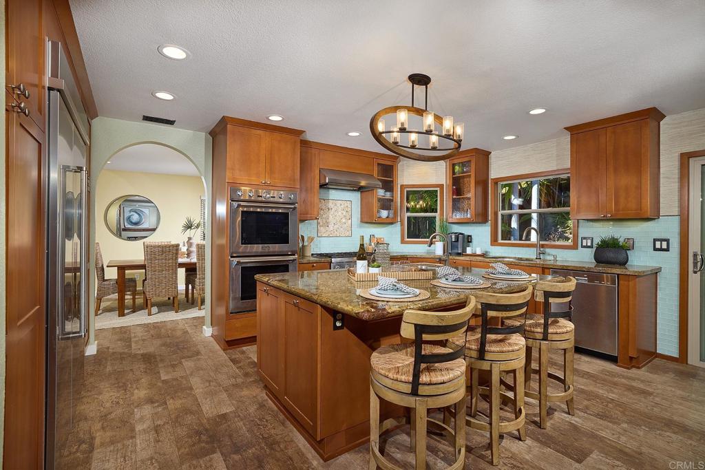 1323 Calle Scott Encinitas, CA 92024 - Photo 8 of 28 a kitchen with a table and chairs in it