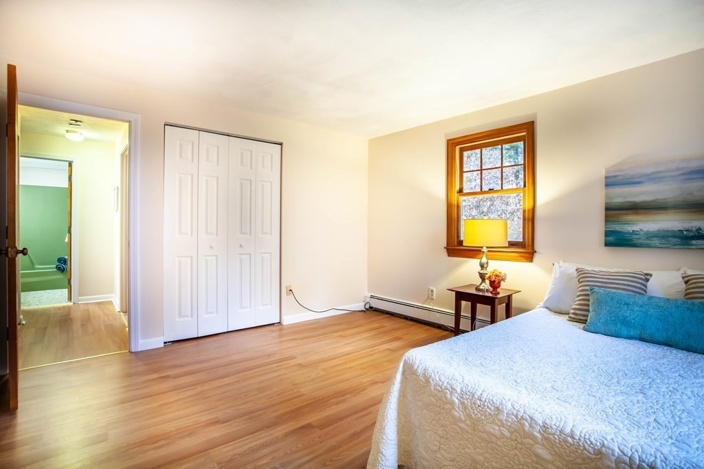 420 Great Road, Unit C2 Acton, MA 01720 - Photo 12 of 20 a bedroom with a bed and wooden floor