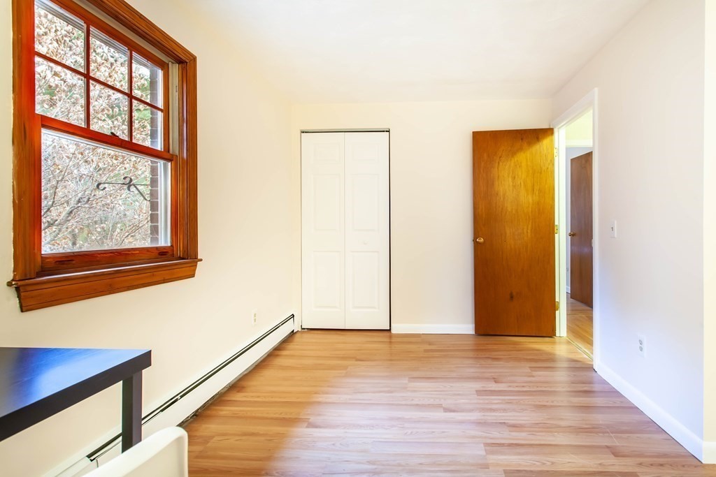 420 Great Road, Unit C2 Acton, MA 01720 - Photo 14 of 20 a view of an empty room with wooden floor and a window