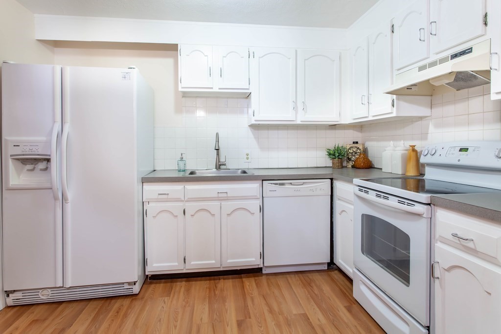 420 Great Road, Unit C2 Acton, MA 01720 - Photo 9 of 20 a kitchen with granite countertop white cabinets and white appliances