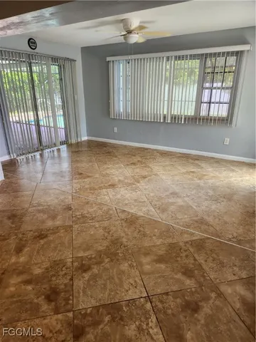 a room with a large window and a rug