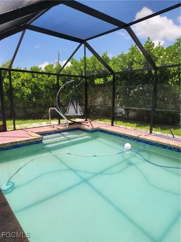 a view of swimming pool with a bench in patio