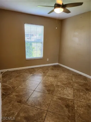 an empty room with a bathroom and a sink