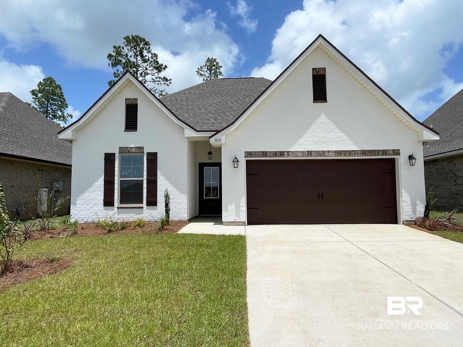 View of front of property with a garage and a front yard
