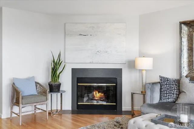a living room with furniture a lamp and a potted plant