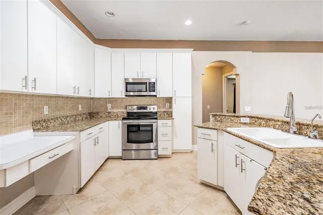 a spacious bathroom with a tub sink and mirror