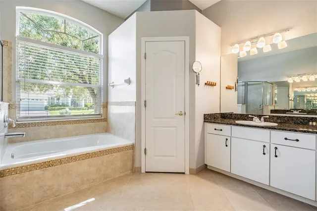 a kitchen with granite countertop kitchen island stainless steel appliances a sink and a refrigerator