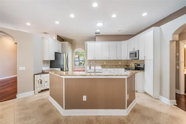 an empty room with wooden floor and a window