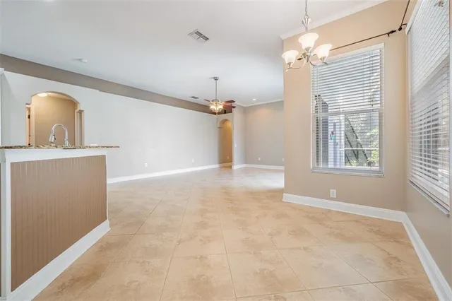 a large kitchen with granite countertop a stove a sink and a refrigerator