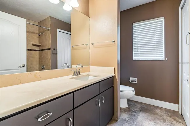 a front view of a house with a yard and palm trees