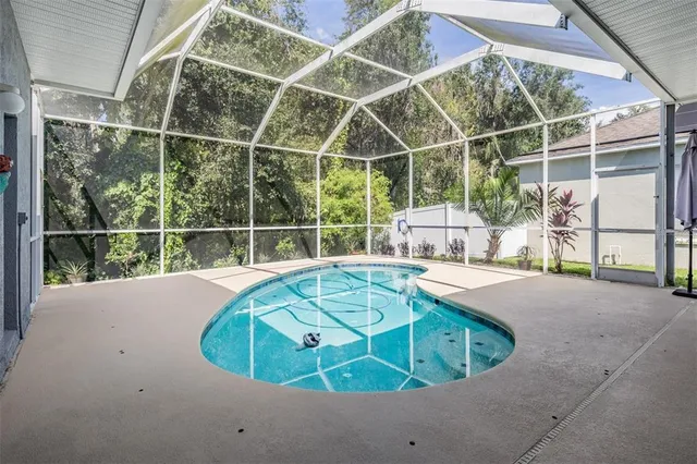 an aerial view of a house with a garden and swimming pool