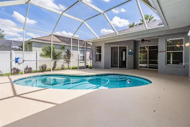 an aerial view of a house with a swimming pool outdoor seating and yard