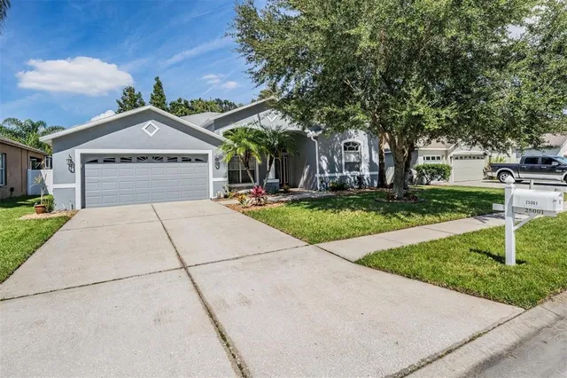 an aerial view of a swimming pool with a yard and seating space