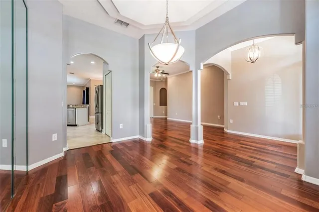 a kitchen with stainless steel appliances granite countertop a stove top oven a sink and a refrigerator