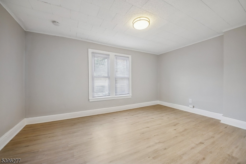 176 Valley Street, Unit 2 South Orange, NJ 07079 - Photo 12 of 30 an empty room with wooden floor and windows