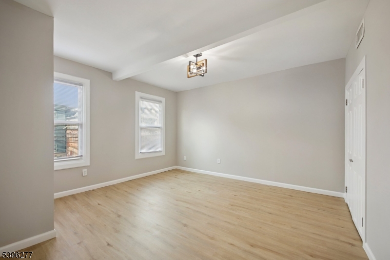176 Valley Street, Unit 2 South Orange, NJ 07079 - Photo 17 of 30 a view of an empty room with wooden floor and a window