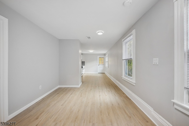176 Valley Street, Unit 2 South Orange, NJ 07079 - Photo 19 of 30 a view of an empty room with a window and wooden floor
