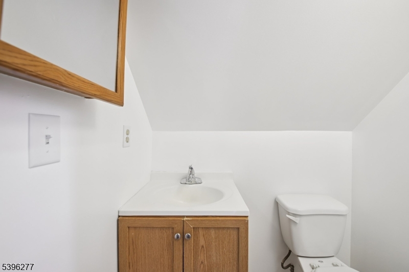 176 Valley Street, Unit 2 South Orange, NJ 07079 - Photo 25 of 30 a bathroom with a sink a toilet and a mirror