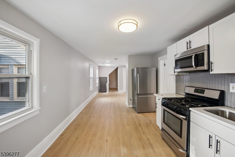 176 Valley Street, Unit 2 South Orange, NJ 07079 - Photo 3 of 30 a kitchen with stainless steel appliances a refrigerator stove and microwave