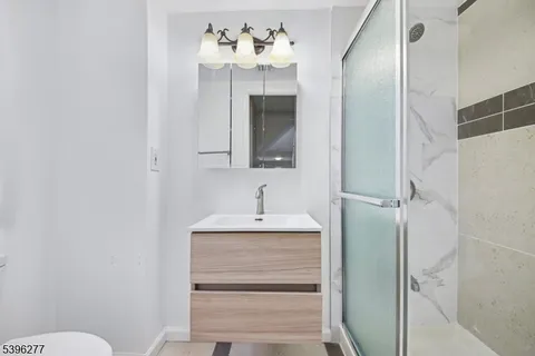 a bathroom with a sink vanity and a mirror