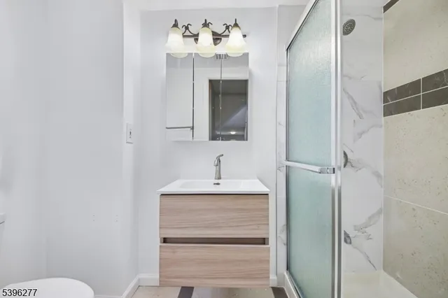 a bathroom with a sink vanity and a mirror