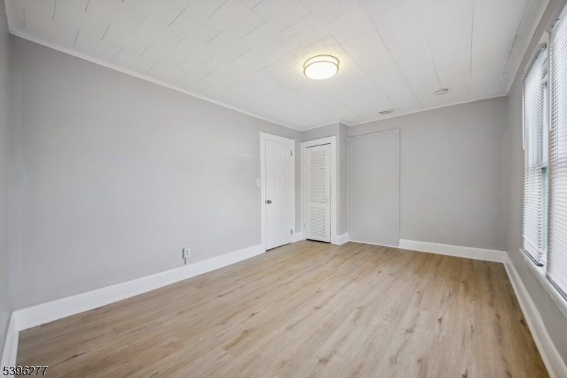 176 Valley Street, Unit 2 South Orange, NJ 07079 - Photo 9 of 30 a view of an empty room with wooden floor and a window