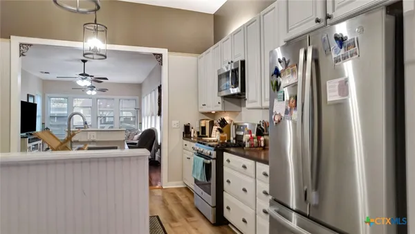 a kitchen with stainless steel appliances granite countertop a refrigerator and a sink