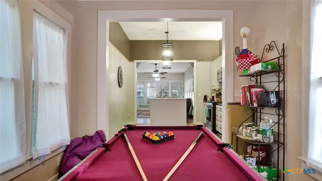 a very nice looking room with a red couch and a chandelier