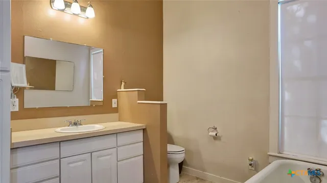 a bathroom with a sink a toilet a shower and a mirror