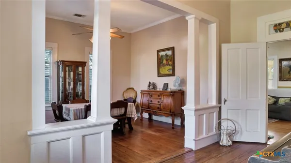 a view of a workspace room with wooden floor and furniture