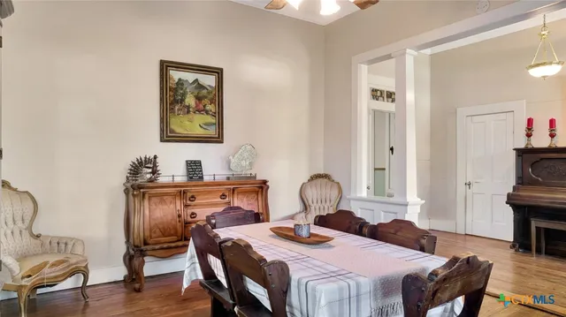 a view of a dining room with furniture and wooden floor