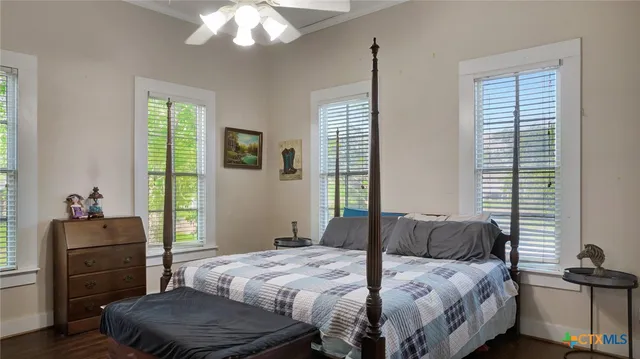 a bedroom with a bed and wooden floor