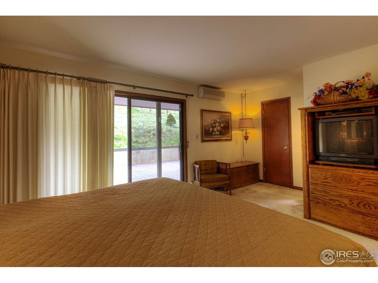 5725 Olde Stage Road Boulder, CO 80302 - Photo 11 of 25 a bedroom with a bed and a television