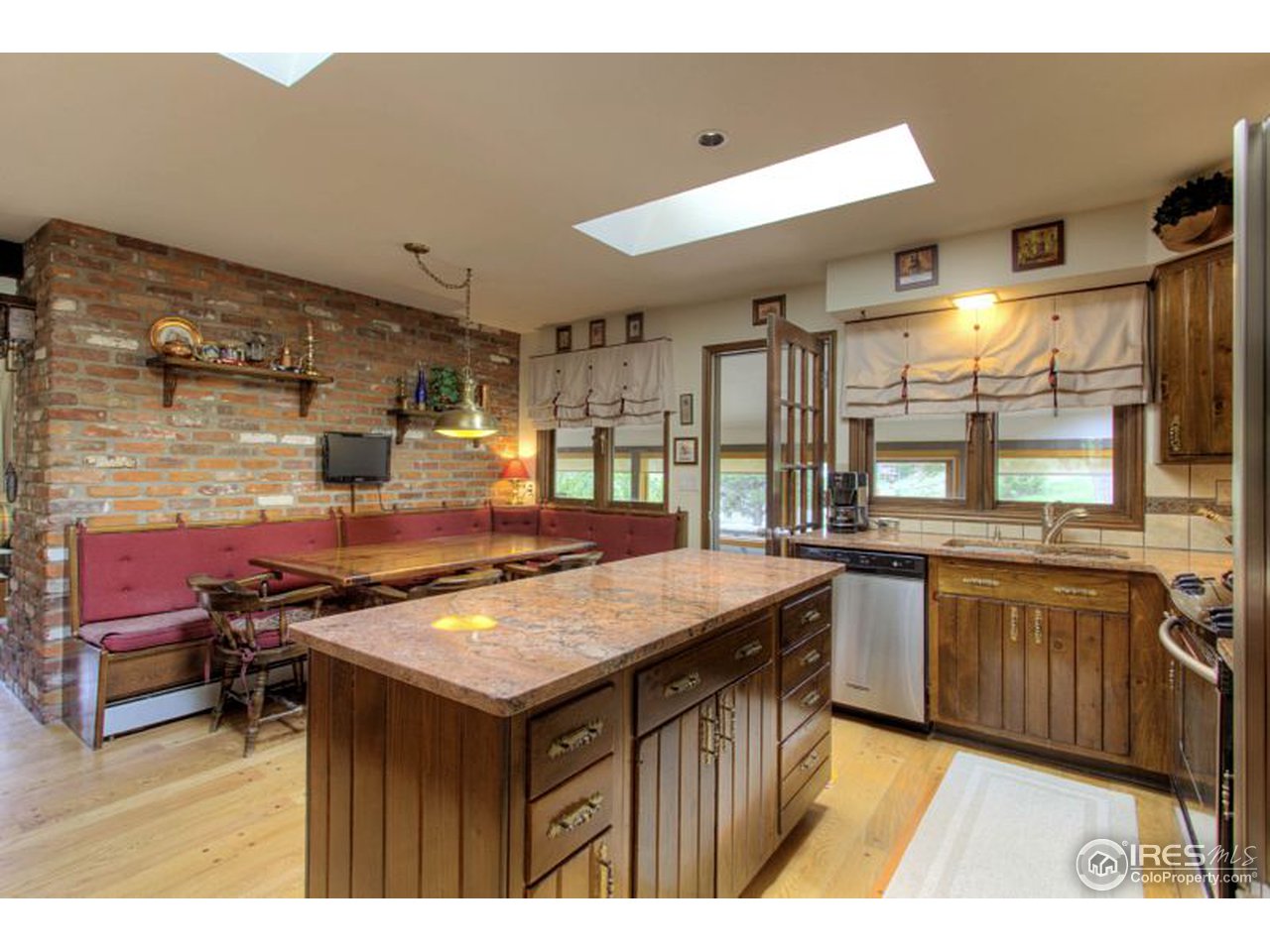 5725 Olde Stage Road Boulder, CO 80302 - Photo 6 of 25 a kitchen with kitchen island a sink stove and cabinets