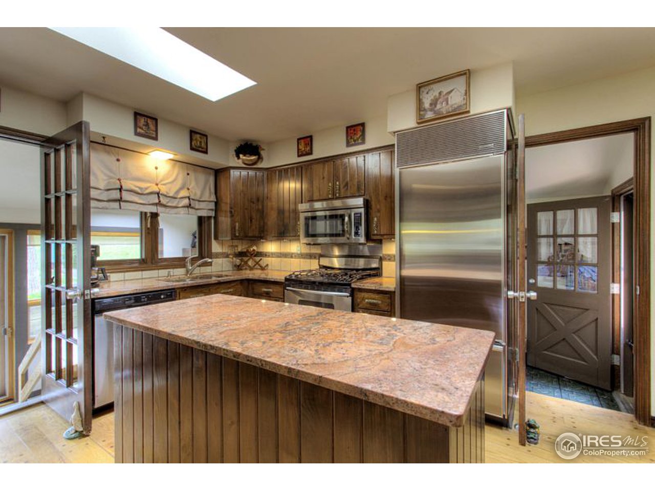 5725 Olde Stage Road Boulder, CO 80302 - Photo 7 of 25 a kitchen with kitchen island a counter top space a sink stainless steel appliances and cabinets