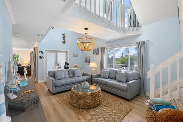 a living room with furniture and a chandelier
