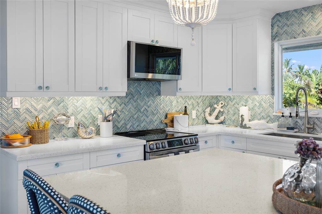 9368 Little Gasparilla Placida, FL 33946 - Photo 20 of 51 a kitchen with a sink and a stove top oven