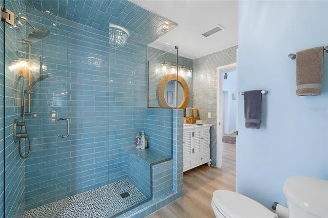 a view of a hallway to an entryway with wooden floor