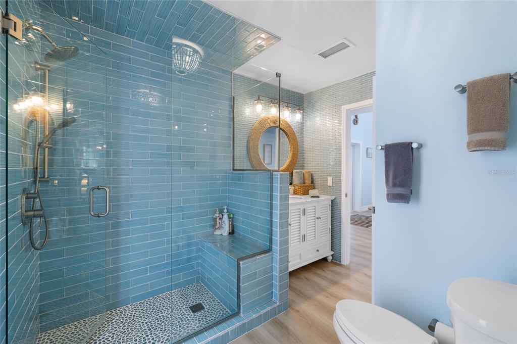 9368 Little Gasparilla Placida, FL 33946 - Photo 25 of 51 a bathroom with a toilet a sink a mirror and shower