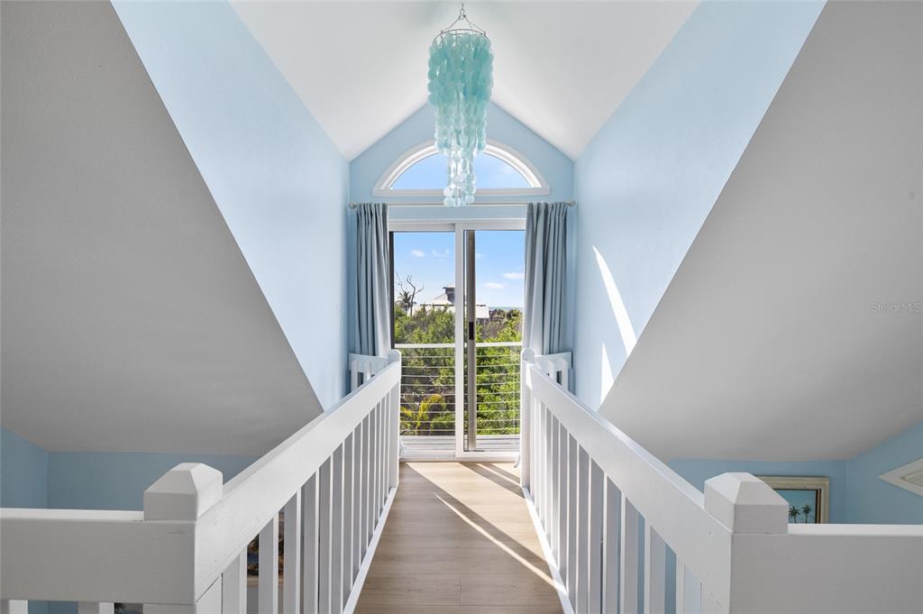 9368 Little Gasparilla Placida, FL 33946 - Photo 26 of 51 a view of a hallway to an entryway with wooden floor
