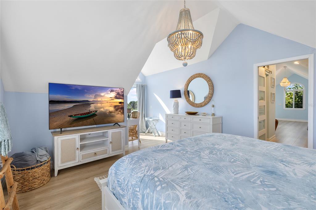 9368 Little Gasparilla Placida, FL 33946 - Photo 35 of 51 a bedroom with a bed and a chandelier