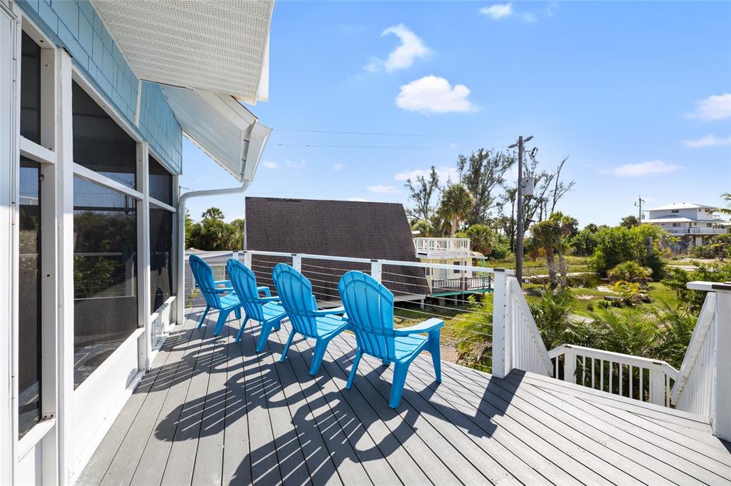 9368 Little Gasparilla Placida, FL 33946 - Photo 4 of 51 a view of a balcony with chairs
