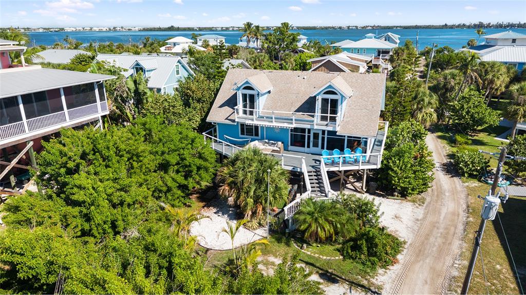 9368 Little Gasparilla Placida, FL 33946 - Photo 44 of 51 an aerial view of a house with a garden and lake view