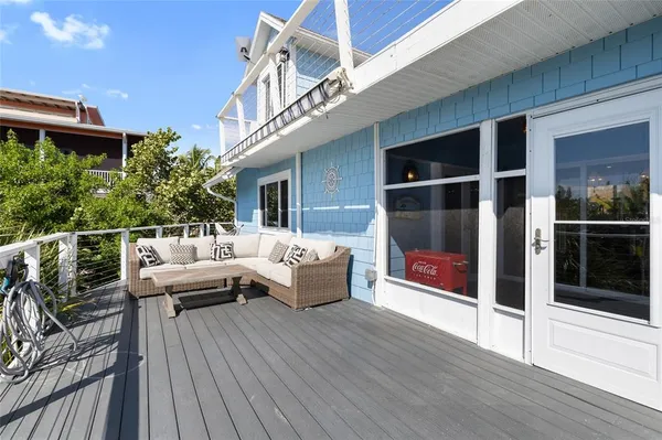 a roof deck with couches and wooden floor